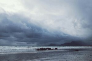 Image of dark stormy clouds over beach
